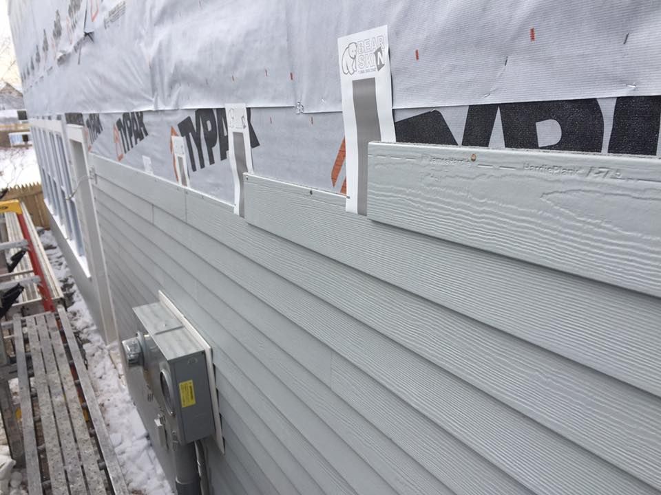 White house exterior with red brick chimney and blue sky.