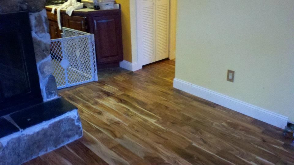 Cottage with screened-in porch, dark roof, and brick chimney under a clear blue sky.