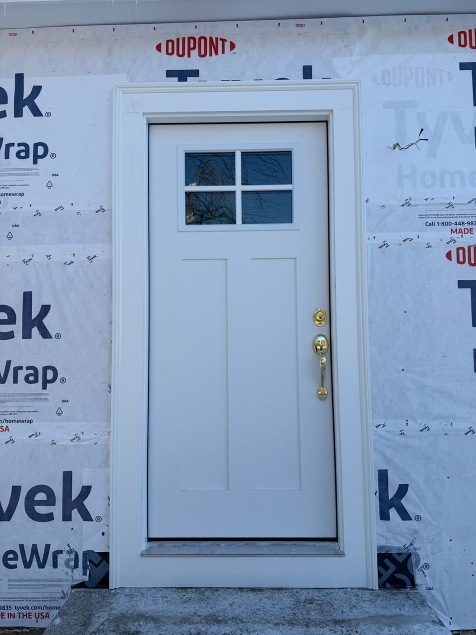 Gray shingled roof with two skylights, a chimney, and a shed in the background.