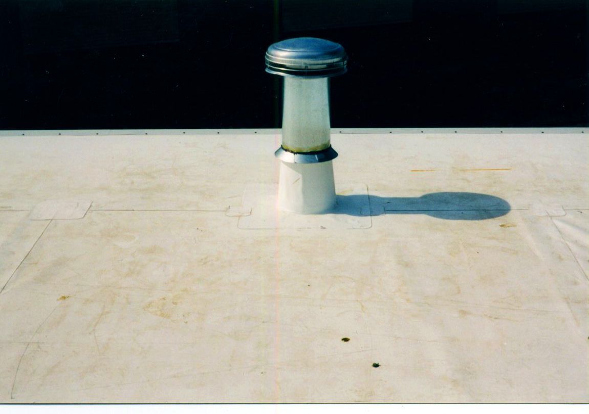 White roof with a ventilation pipe; the pipe has a silver top.