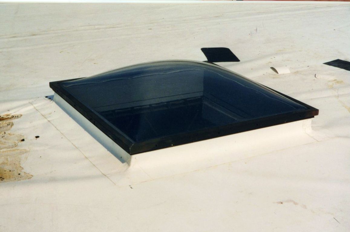Skylight on white roof; a square with a curved dark glass top and black border.
