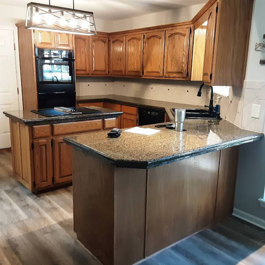Kitchen with wooden cabinets, granite countertops, and built-in appliances.