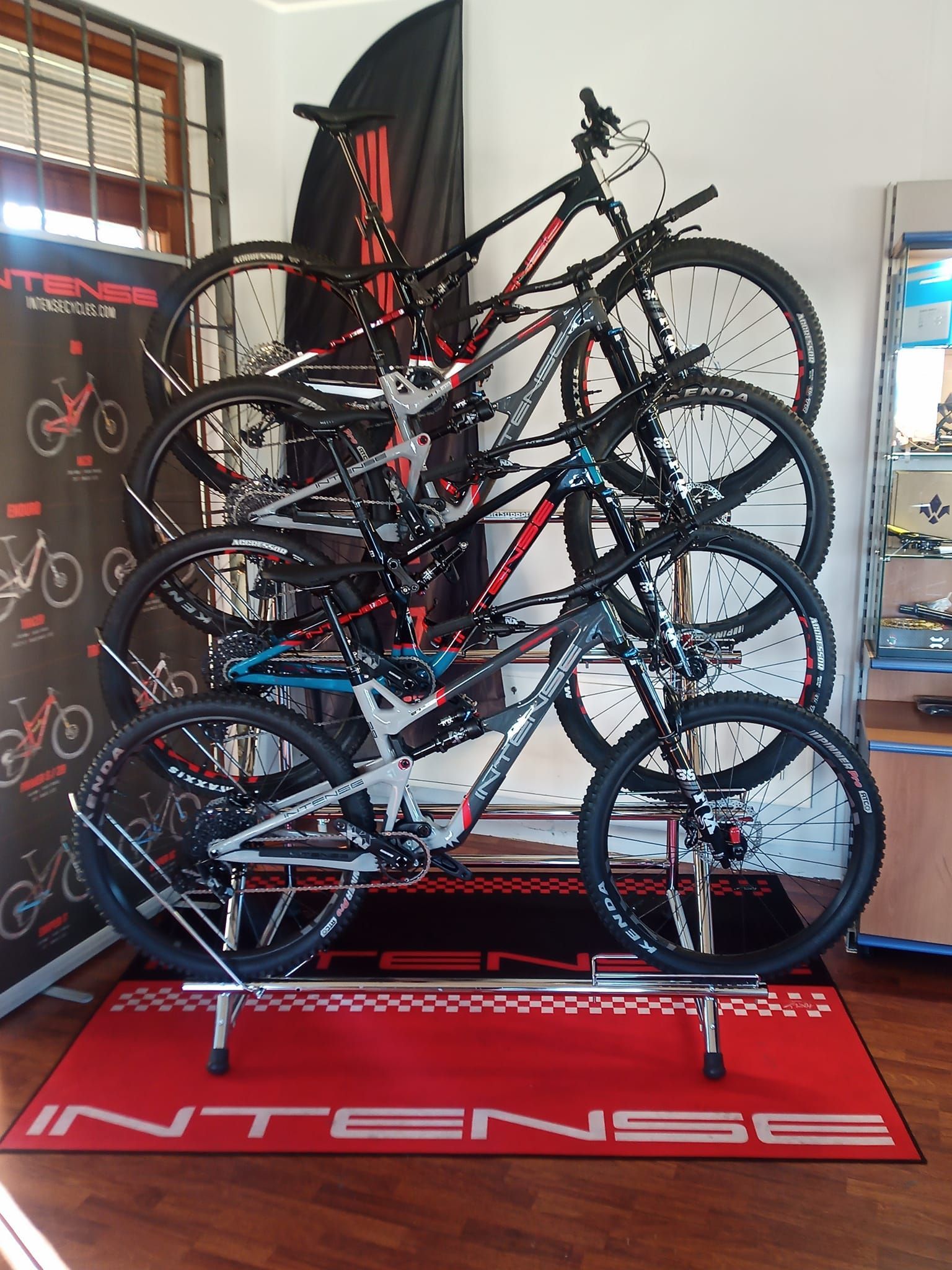 Un mucchio di biciclette sono accatastate una sopra l'altra su una rastrelliera in una stanza.