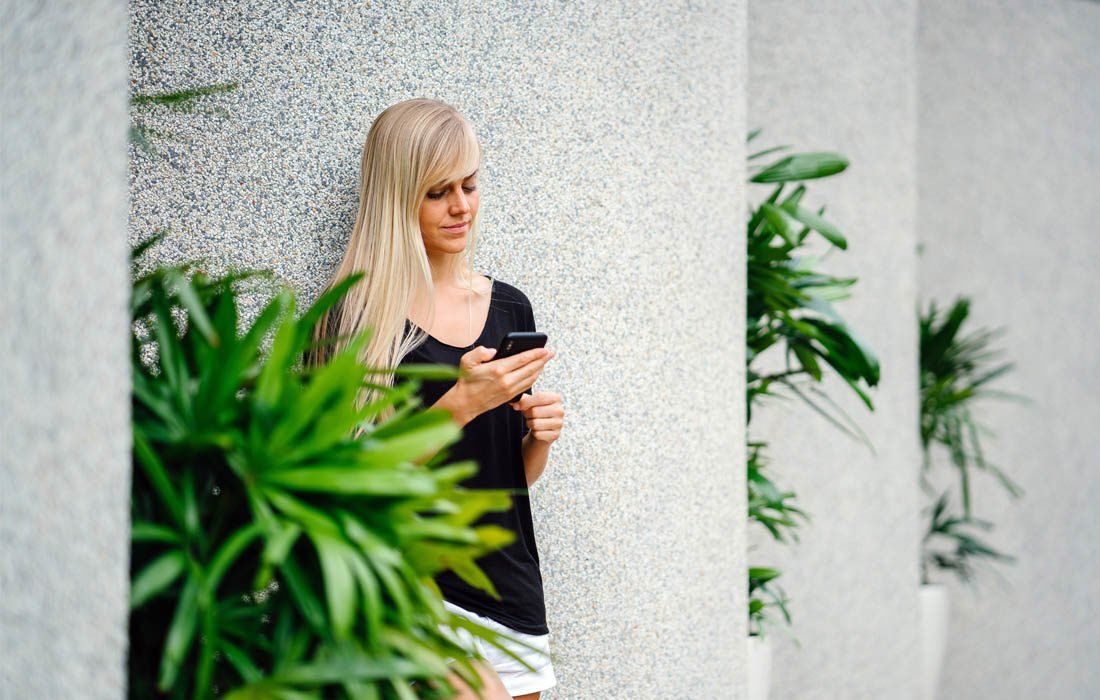 A Woman Focus Her Phone — Financial Advisor in Kingscliff, NSW