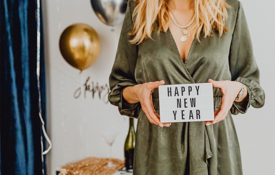 A Woman Holding Her Hands On Box 'Happy New Year' — Financial Advisor in Kingscliff, NSW