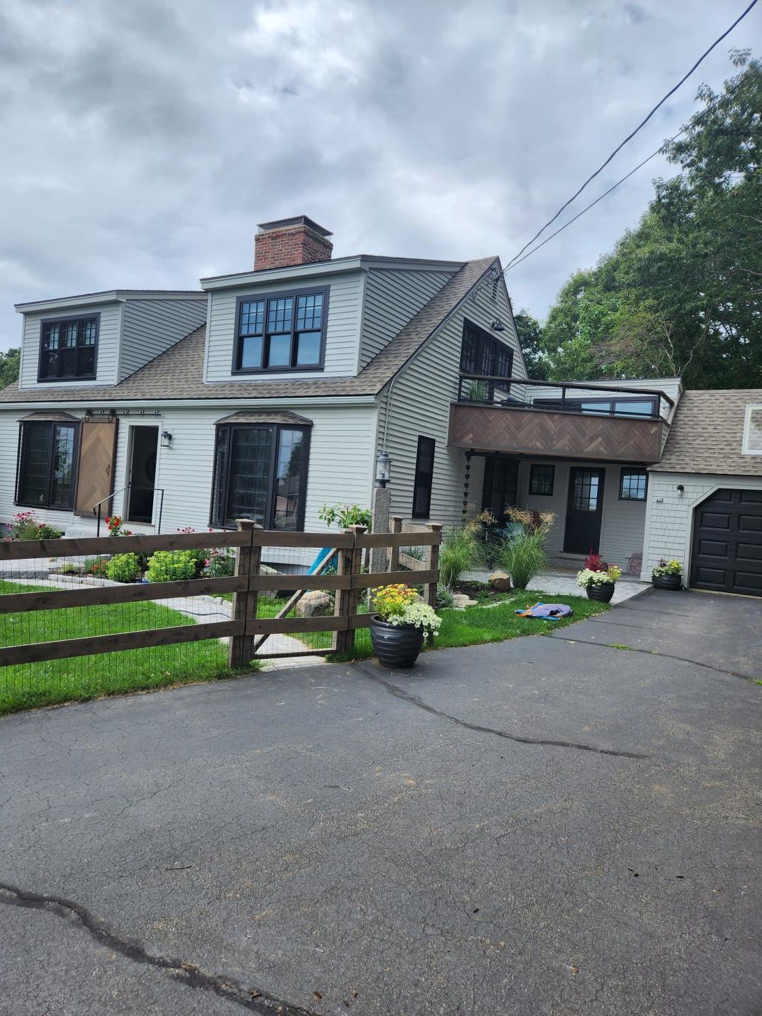 A close up of a metal fence with a bush in the background.