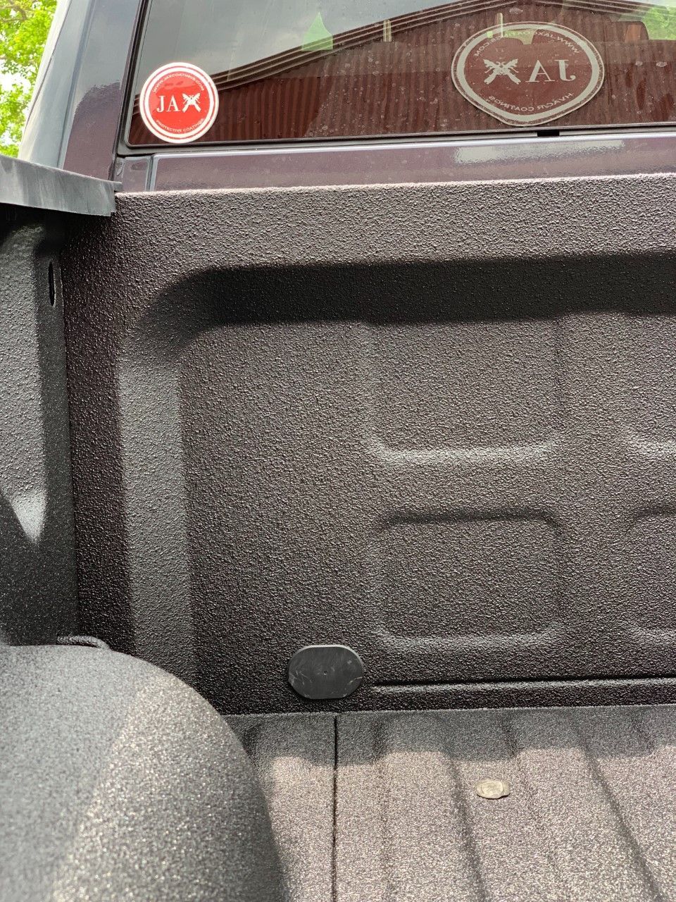 A close up of the back of a truck with a sticker on the back window.