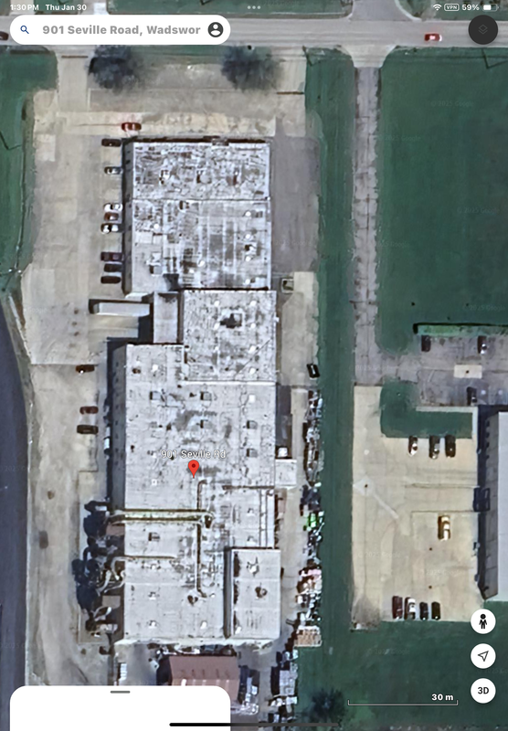 Overhead view of a white-roofed industrial building