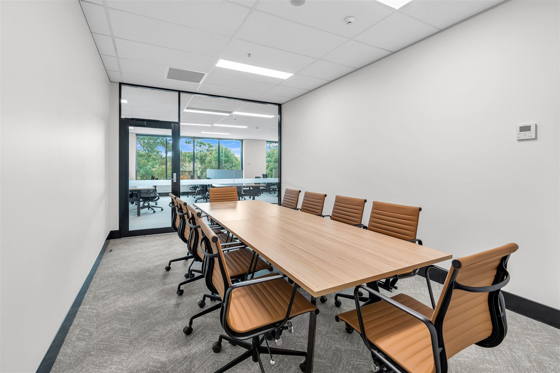 A Conference Room With a Long Wooden Table and Chairs — Moltus Construction in Braddon,  ACT