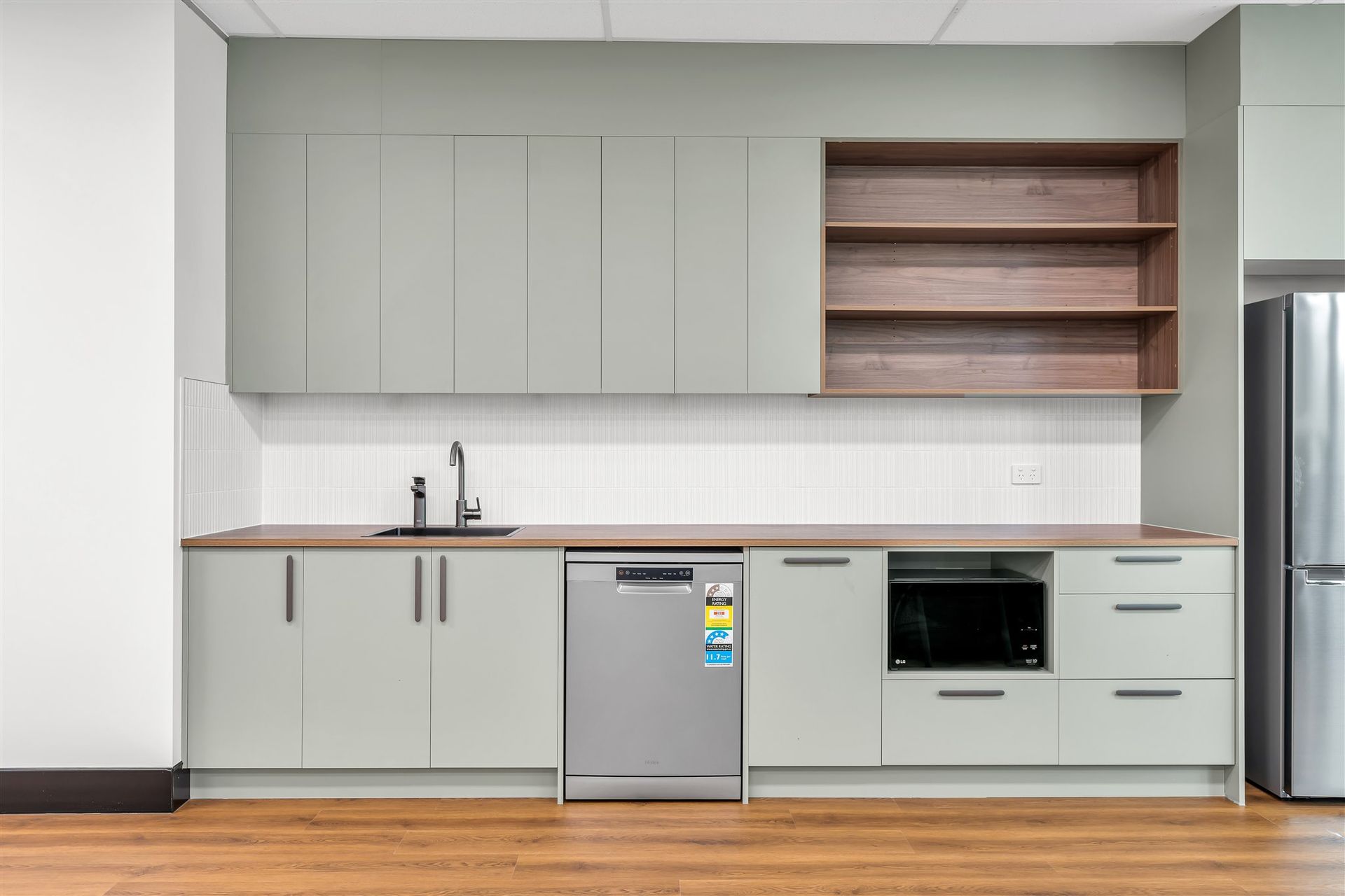 A Kitchen With a Sink a Dishwasher and a Refrigerator — Moltus Construction in Braddon,  ACT