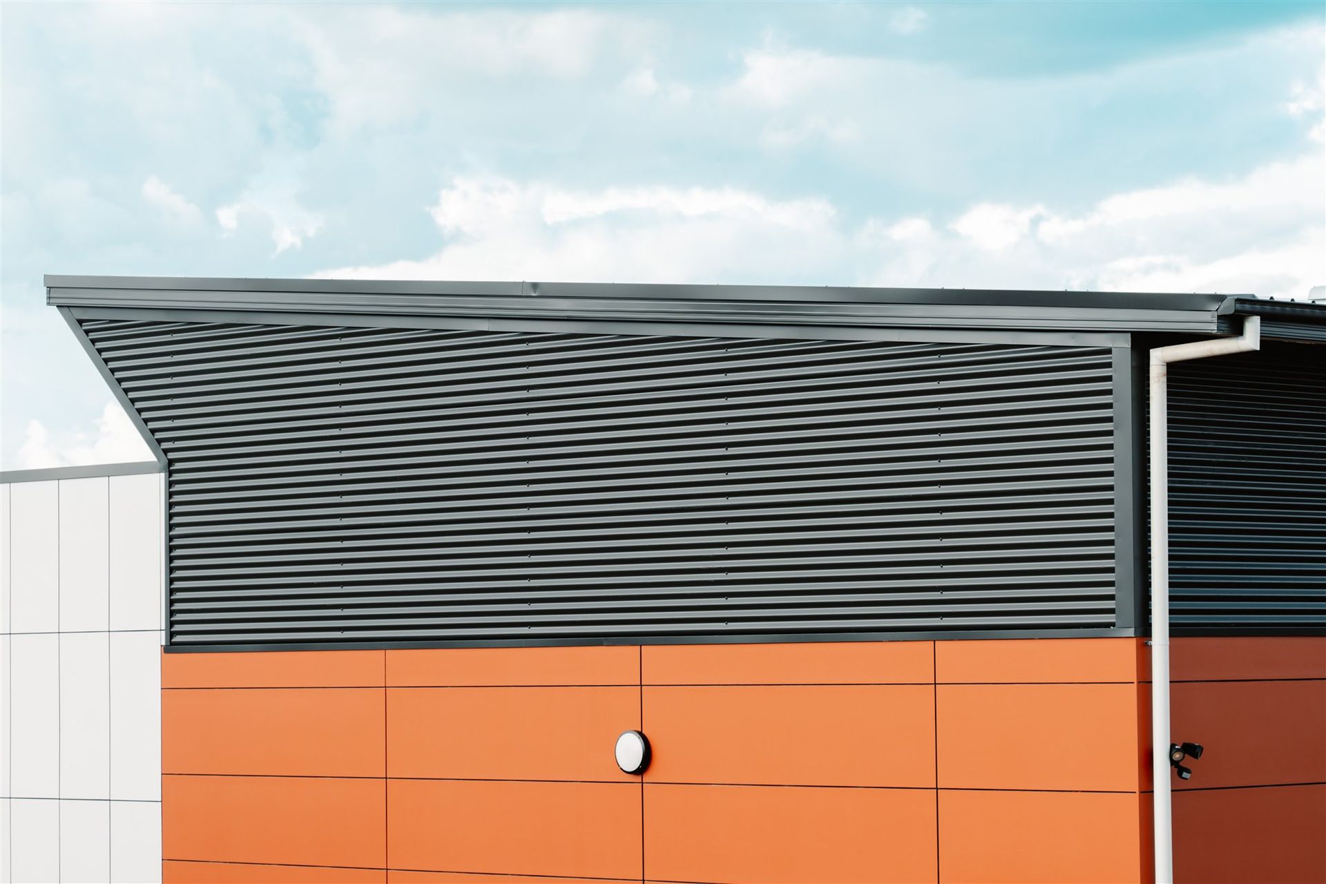 A Drawing of a Building With Orange and Black Tiles and a Blue Sky in the Background — Moltus Construction in Braddon,  ACT