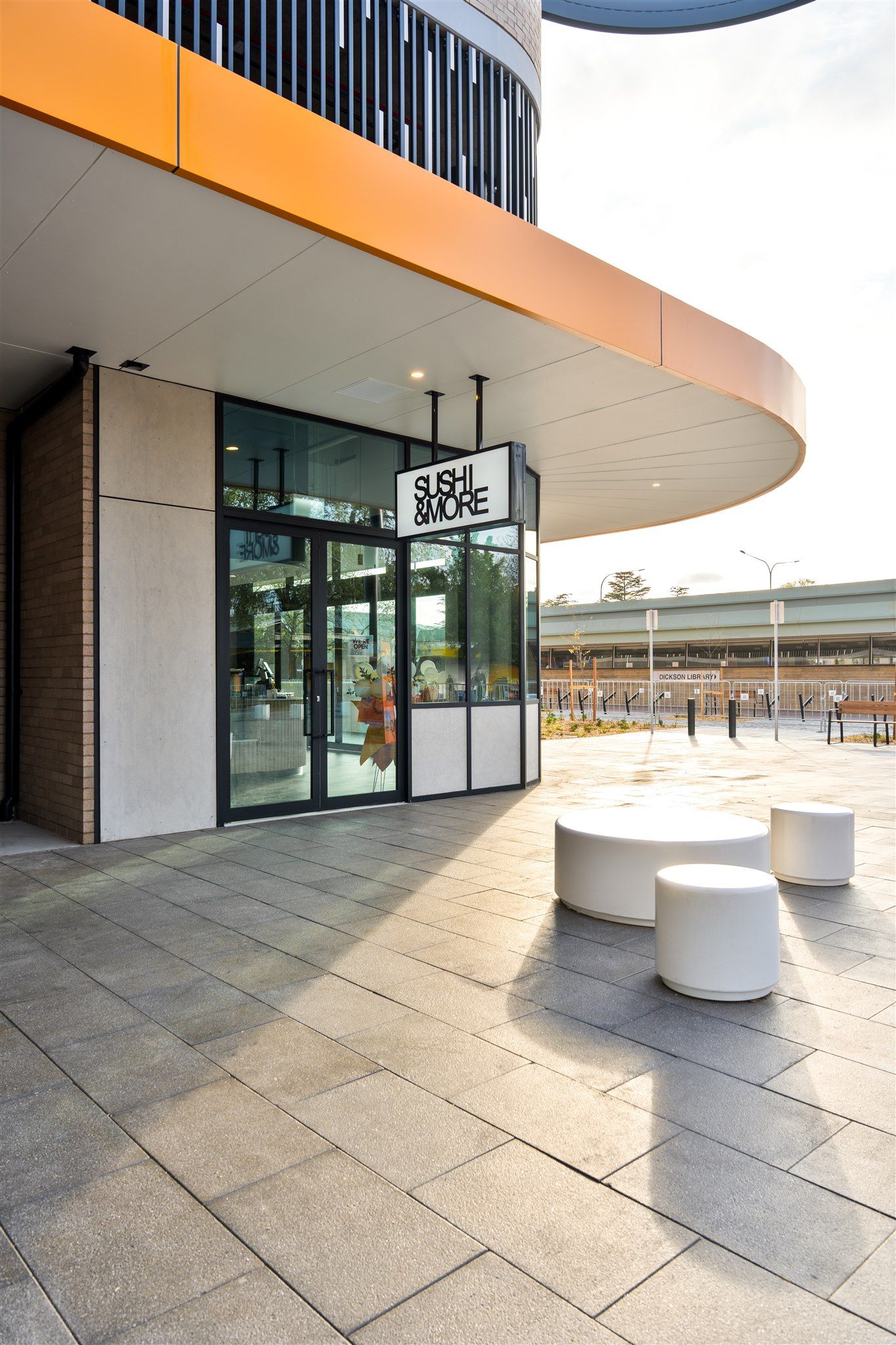 A Building With a Lot of Windows and a Sign on It — Moltus Construction in Braddon,  ACT