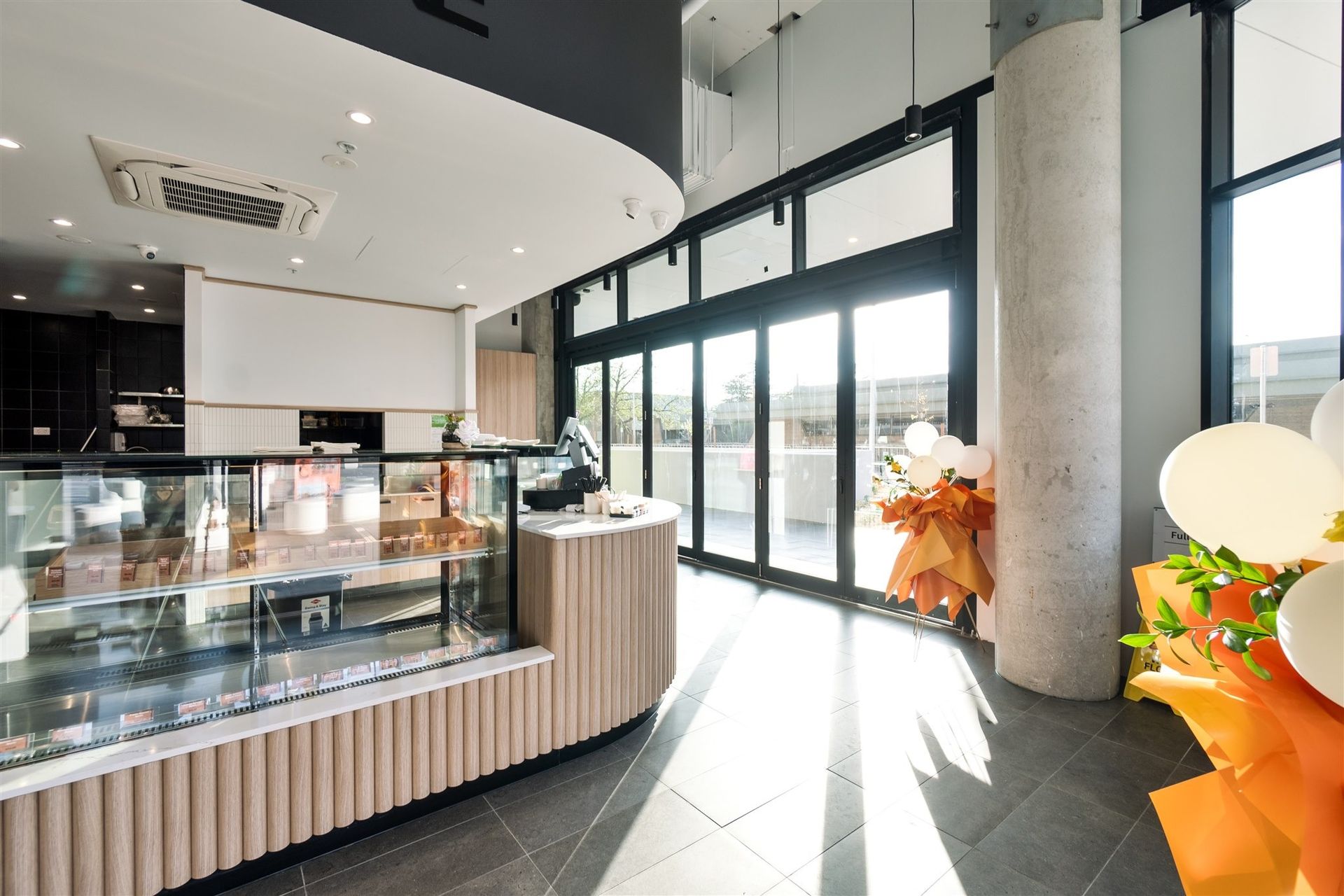 A Large Room With a Lot of Windows and a Display Case — Moltus Construction in Braddon,  ACT