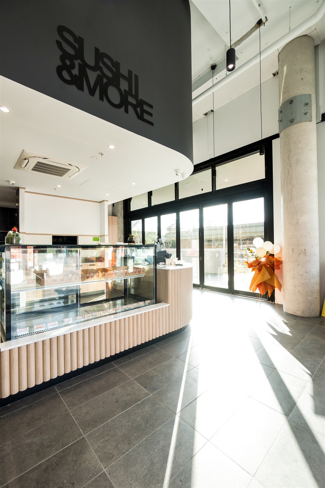 A Restaurant With a Lot of Windows and a Sign That Says Sushi & More — Moltus Construction in Braddon,  ACT