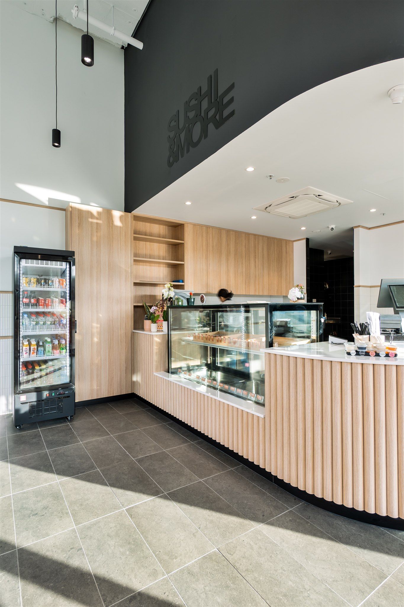 A Restaurant With a Wooden Counter and a Glass Display Case — Moltus Construction in Braddon,  ACT