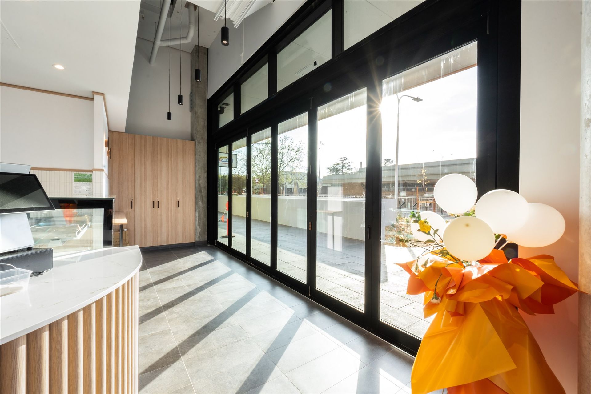 A Large Room With a Lot of Windows and Balloons — Moltus Construction in Braddon,  ACT