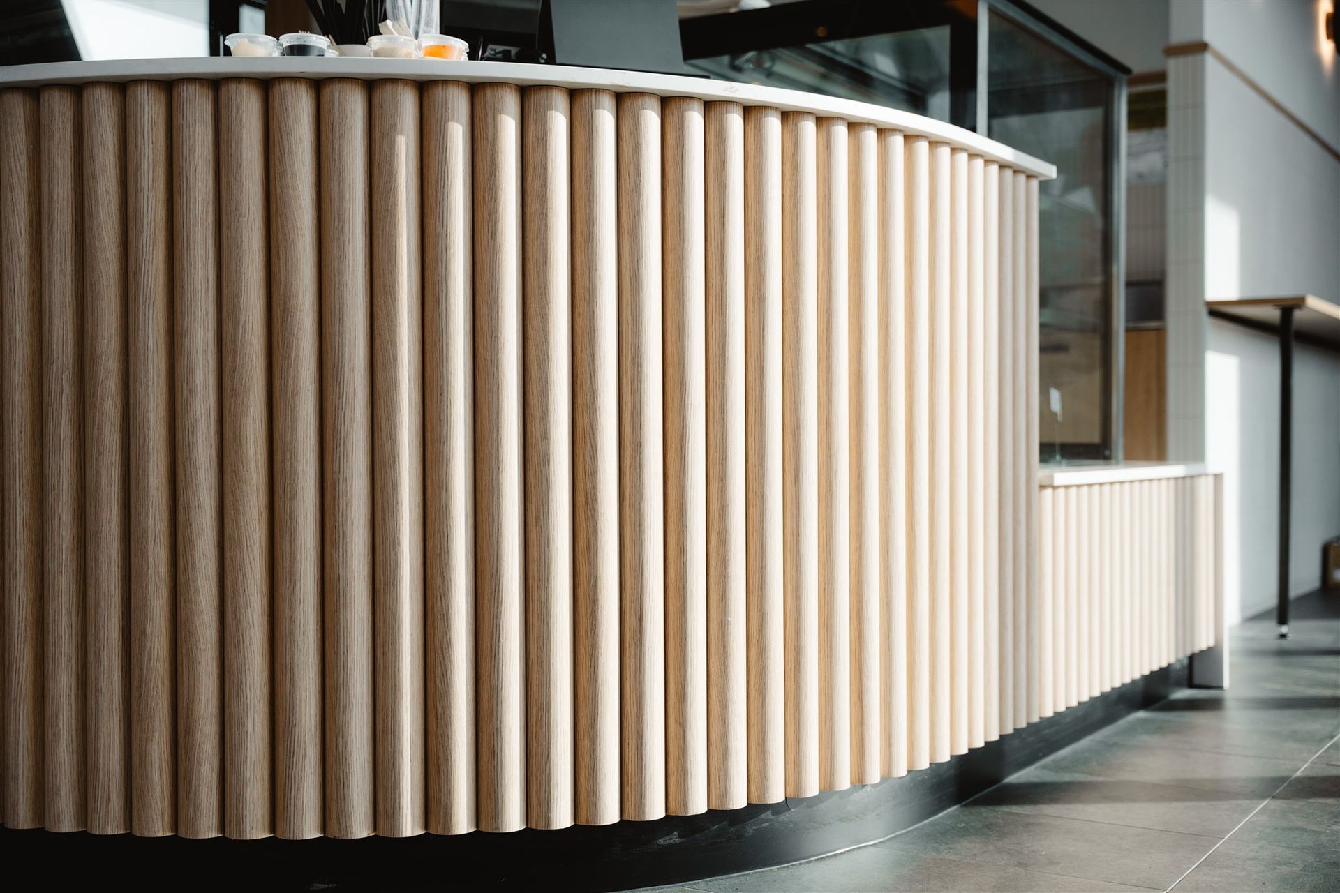 A Close Up of a Wooden Counter in a Restaurant — Moltus Construction in Braddon,  ACT