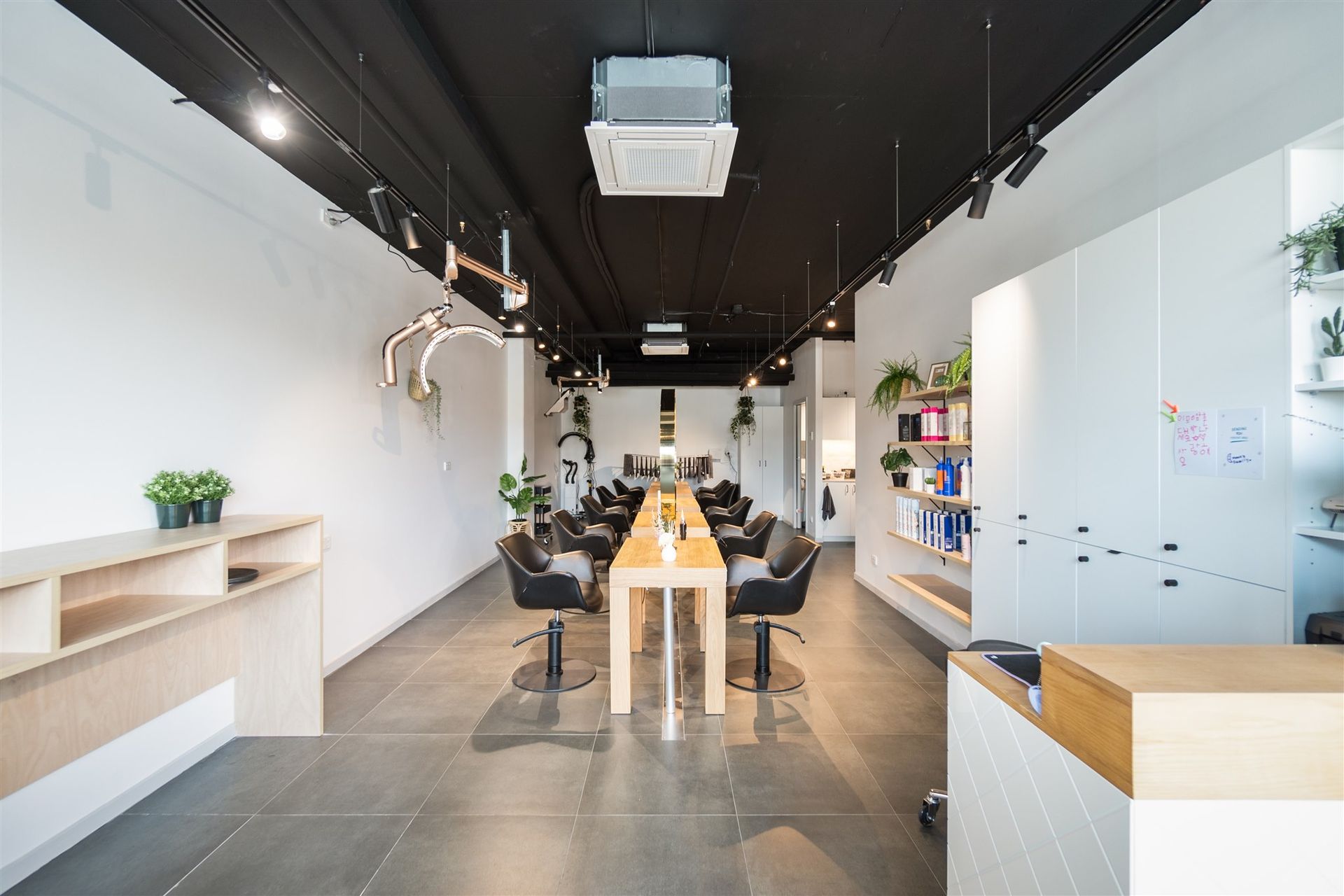 A Large Room With a Long Table and Chairs in a Salon — Moltus Construction in Braddon,  ACT