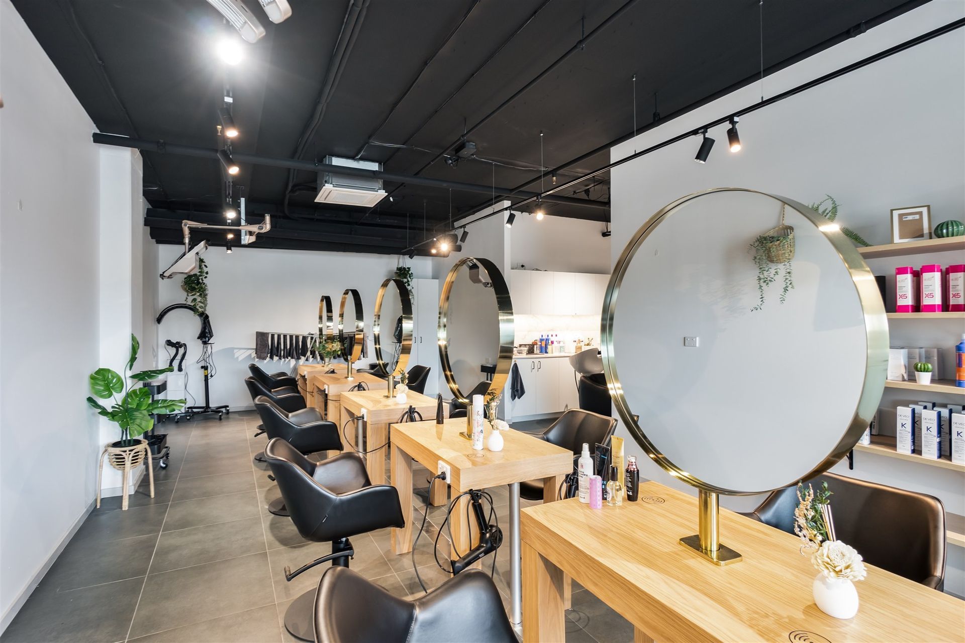 A Salon With a Lot of Chairs, Tables and Mirrors — Moltus Construction in Braddon,  ACT
