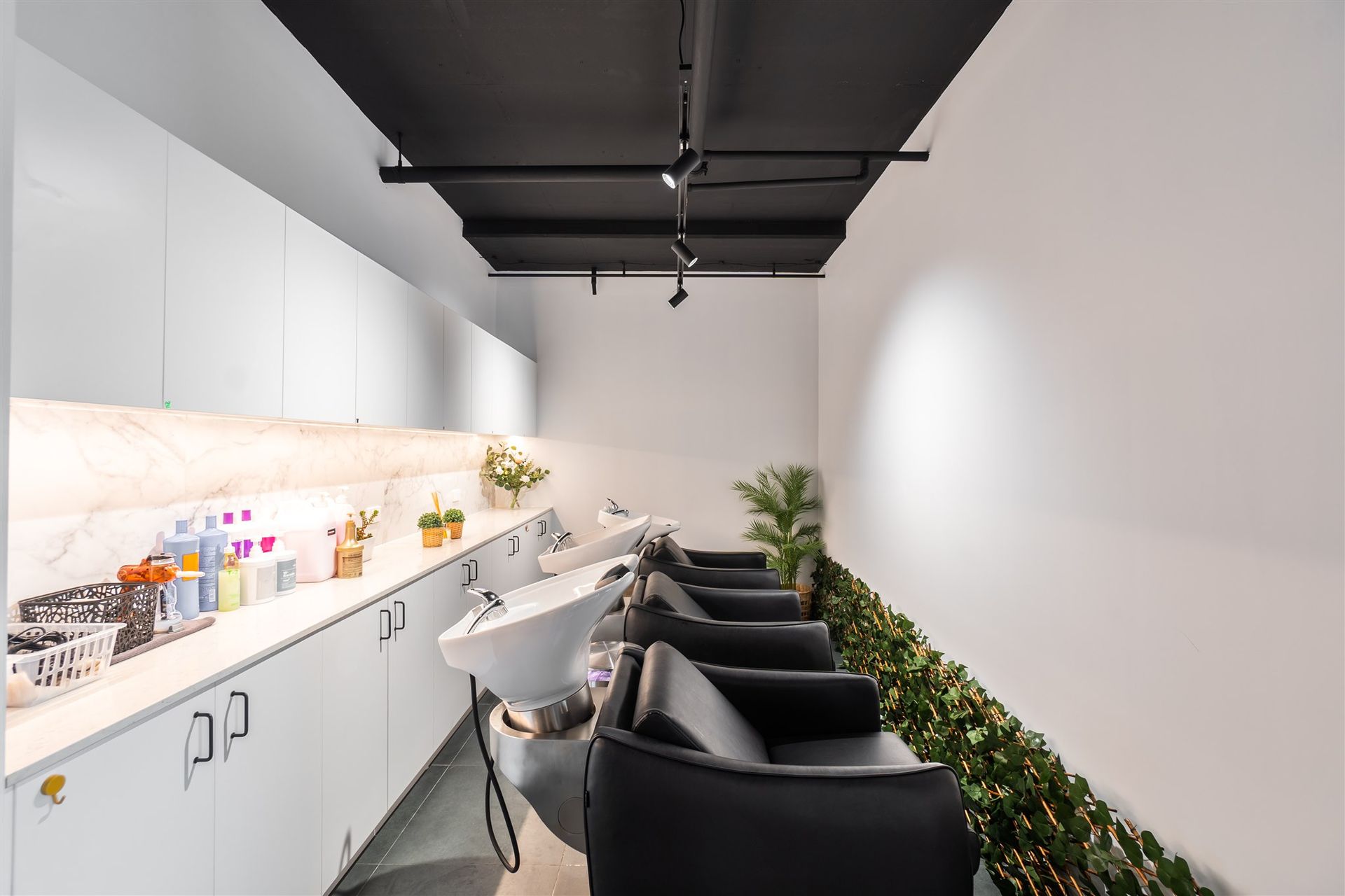 A Long Room With a Lot of Chairs and Sinks in a Hair Salon — Moltus Construction in Braddon,  ACT