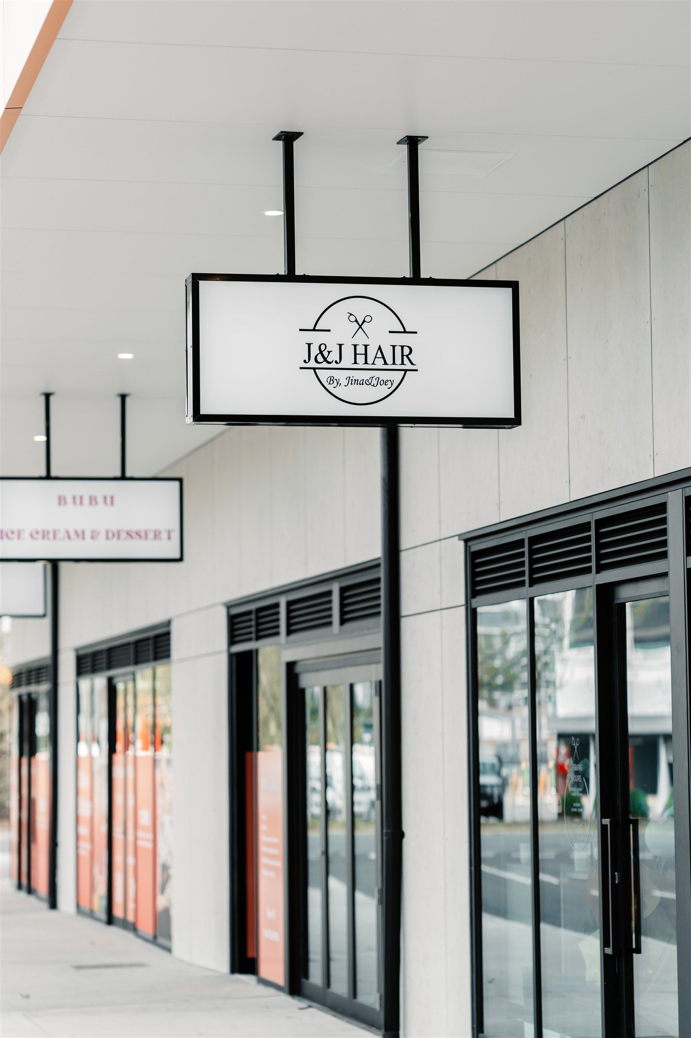 A Store Front With a Sign Hanging From the Ceiling — Moltus Construction in Braddon,  ACT