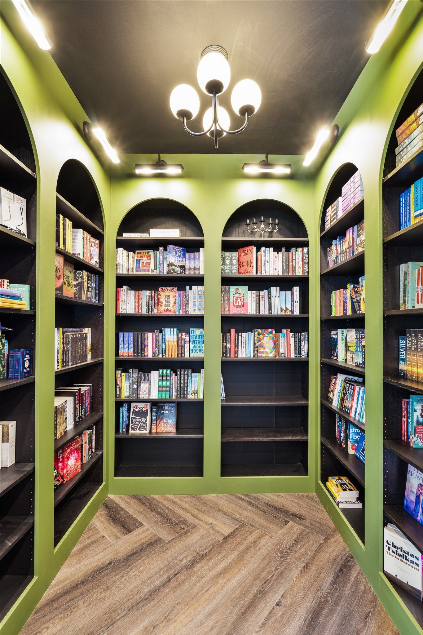 A Library Filled With Lots of Books and a Chandelier — Moltus Construction in Braddon, ACT