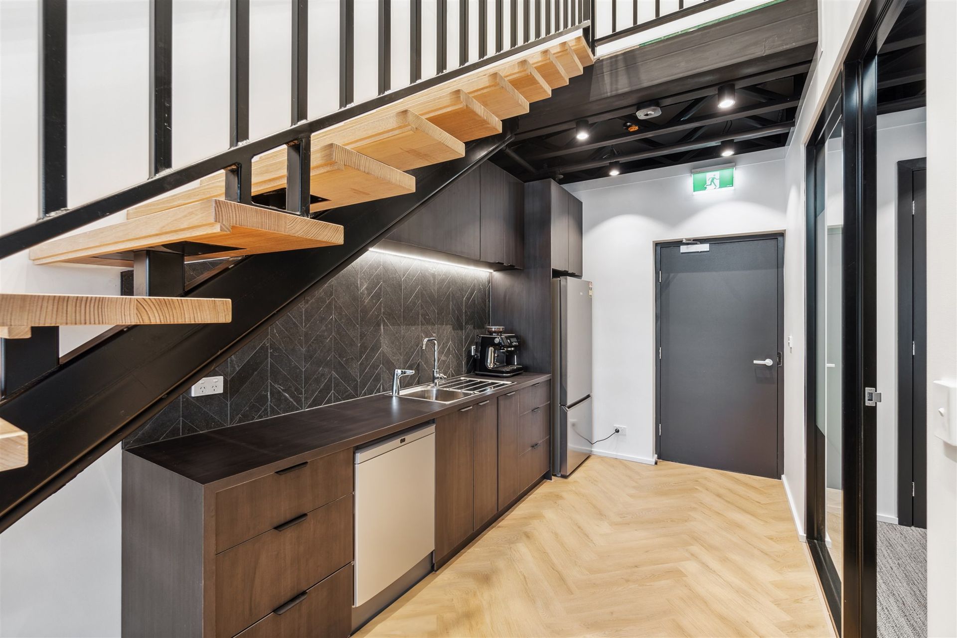 A Kitchen With a Staircase Leading Up to the Second Floor — Moltus Construction in Braddon, ACT