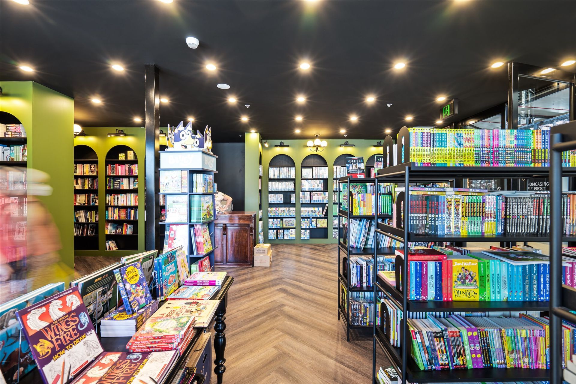 A Book Store Filled With Lots of Books and Shelves — Moltus Construction in Braddon, ACT