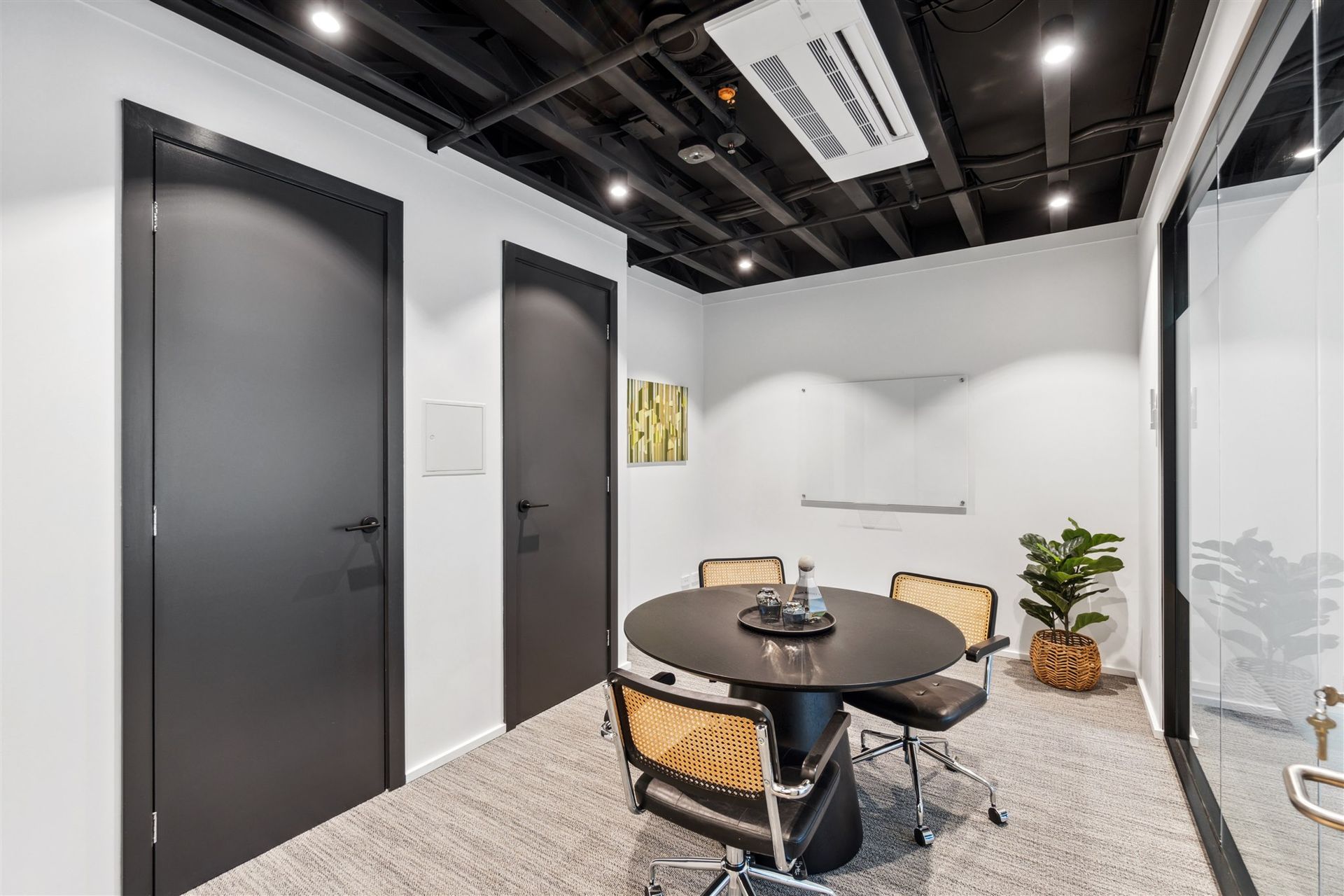A Conference Room With a Round Table and Chairs in It — Moltus Construction in Braddon, ACT