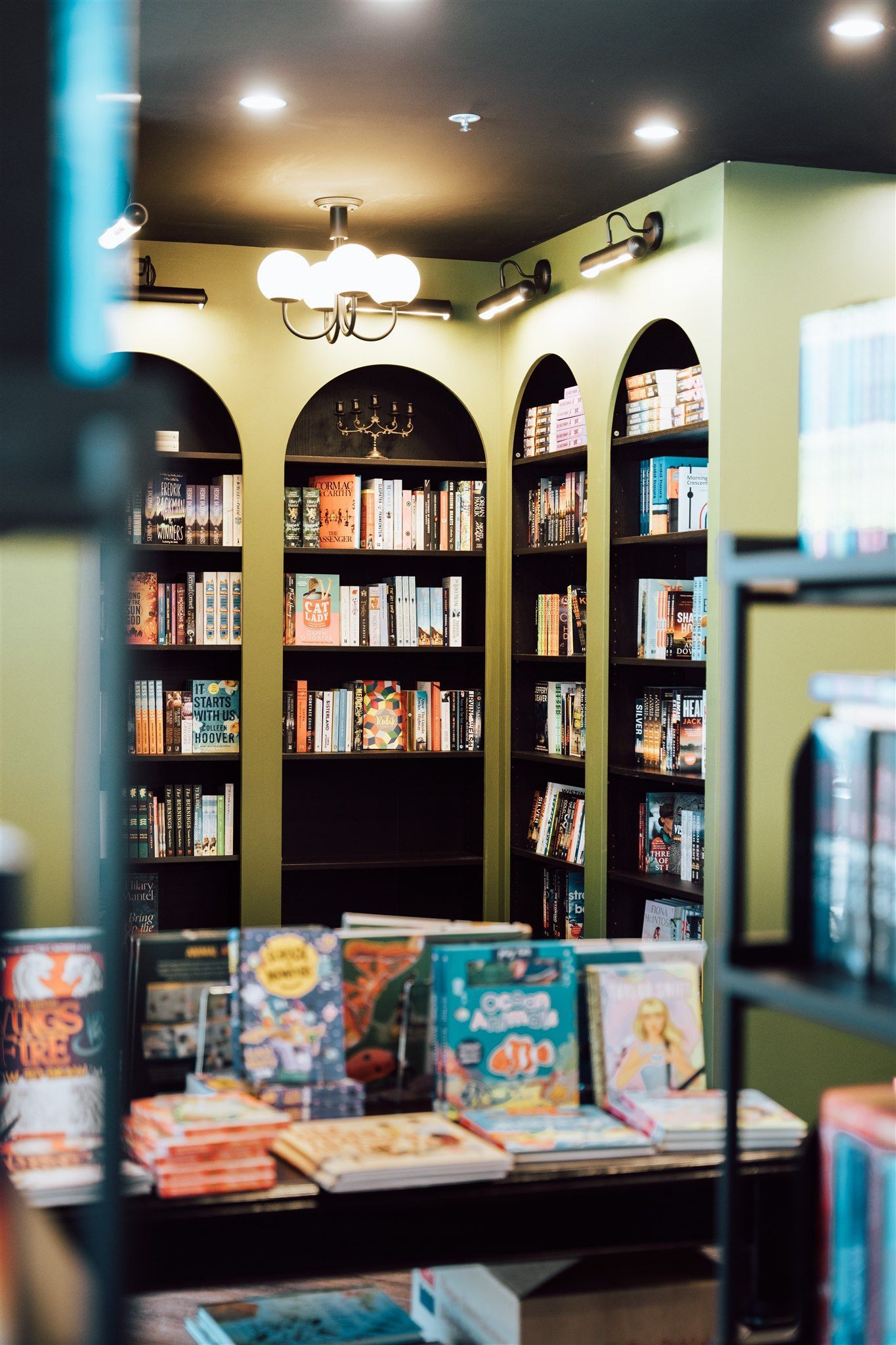 A Bookstore Filled With Lots of Books on Shelves and Tables — Moltus Construction in Braddon, ACT