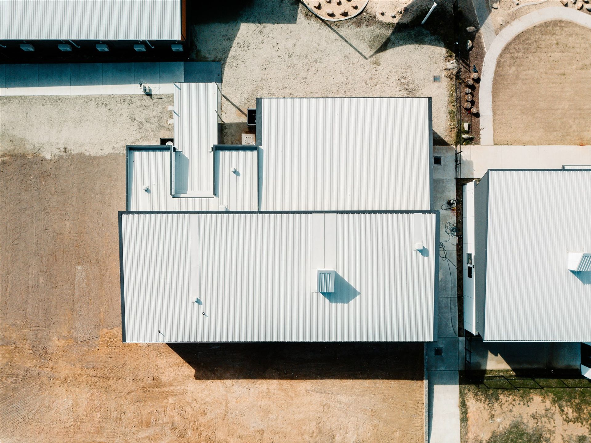 An Aerial View of a Building With a White Roof — Moltus Construction in Braddon,  ACT