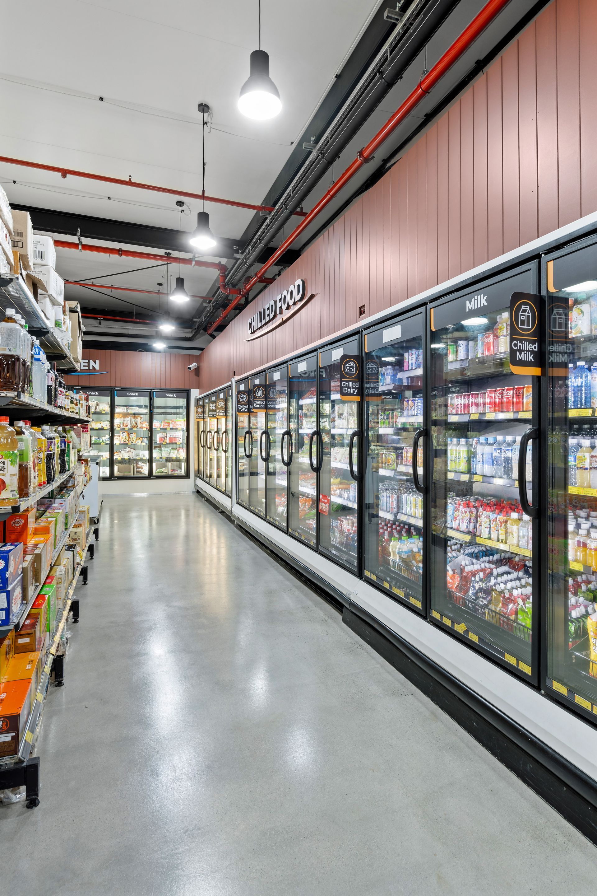 A Grocery Store With a Lot of Refrigerators and Shelves — Moltus Construction in Braddon,  ACT