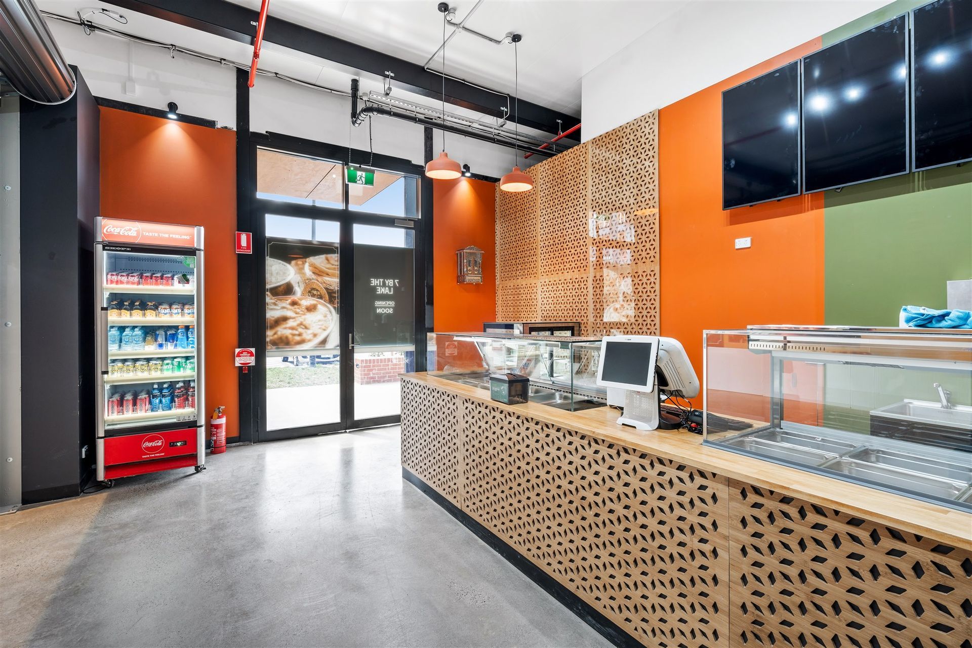The Inside of a Restaurant With a Counter and a Refrigerator — Moltus Construction in Braddon,  ACT