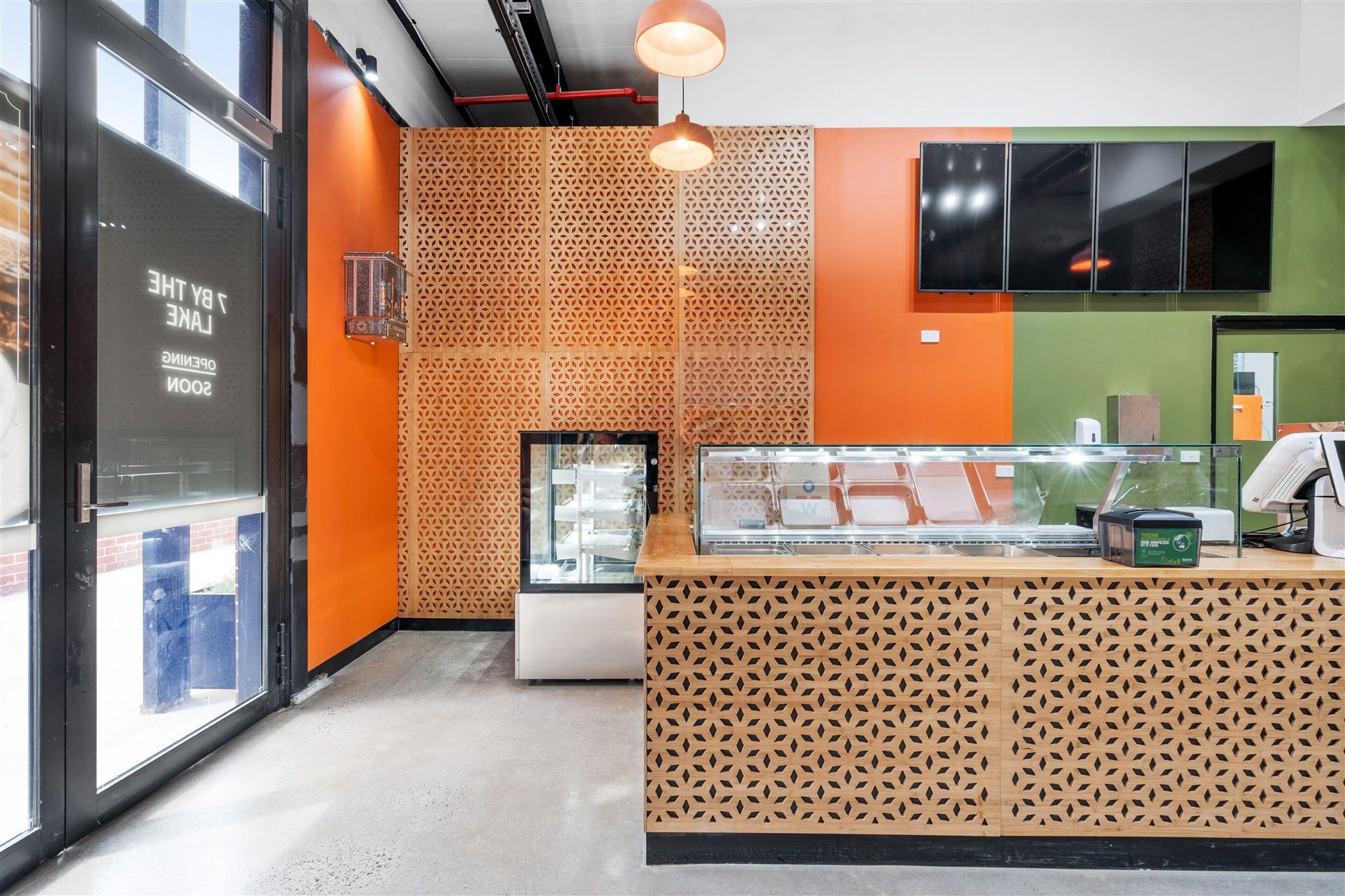 The Inside of a Restaurant With a Counter and a Display Case — Moltus Construction in Braddon,  ACT