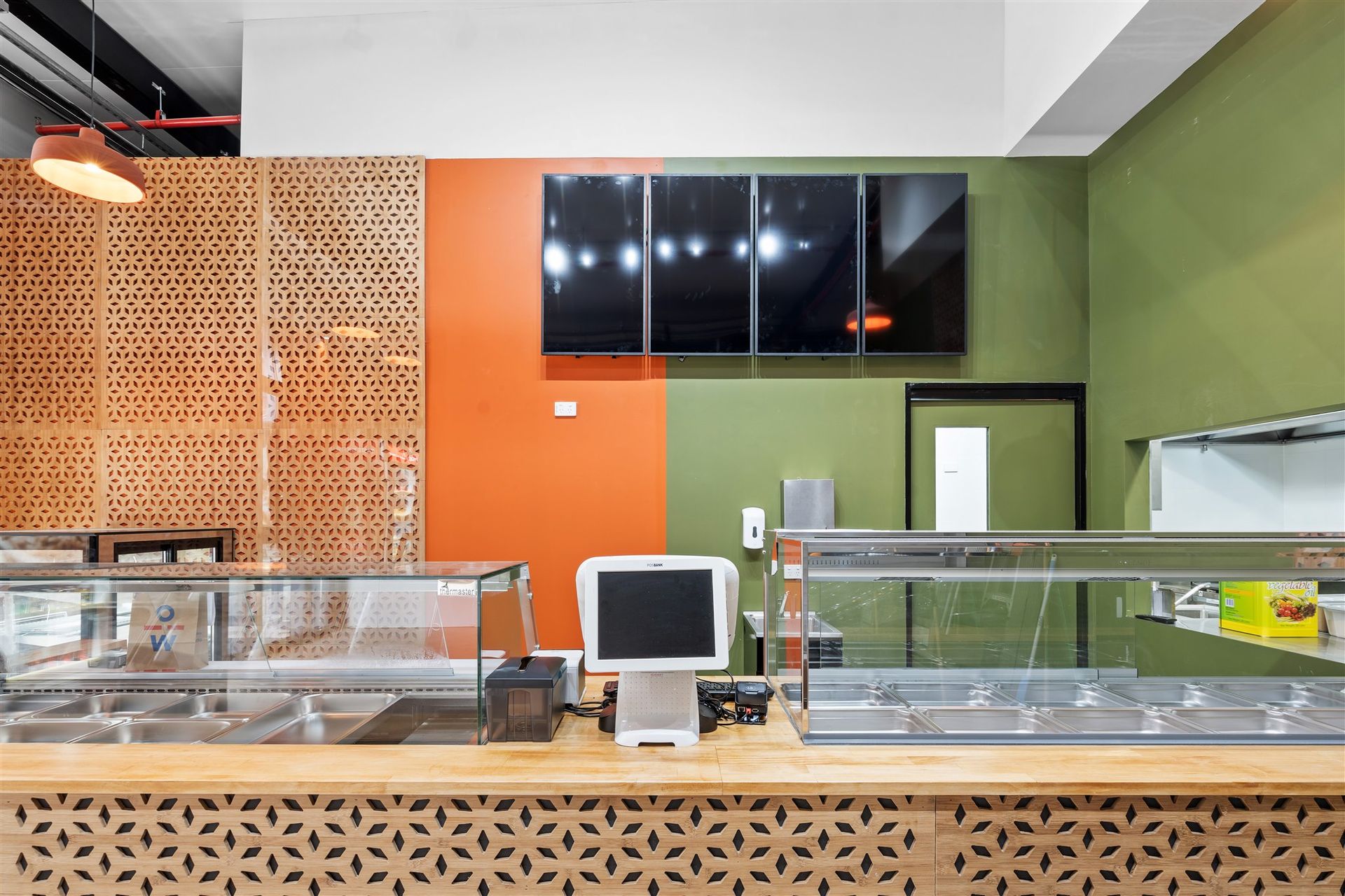 A Counter in a Restaurant With a Computer on It — Moltus Construction in Braddon,  ACT