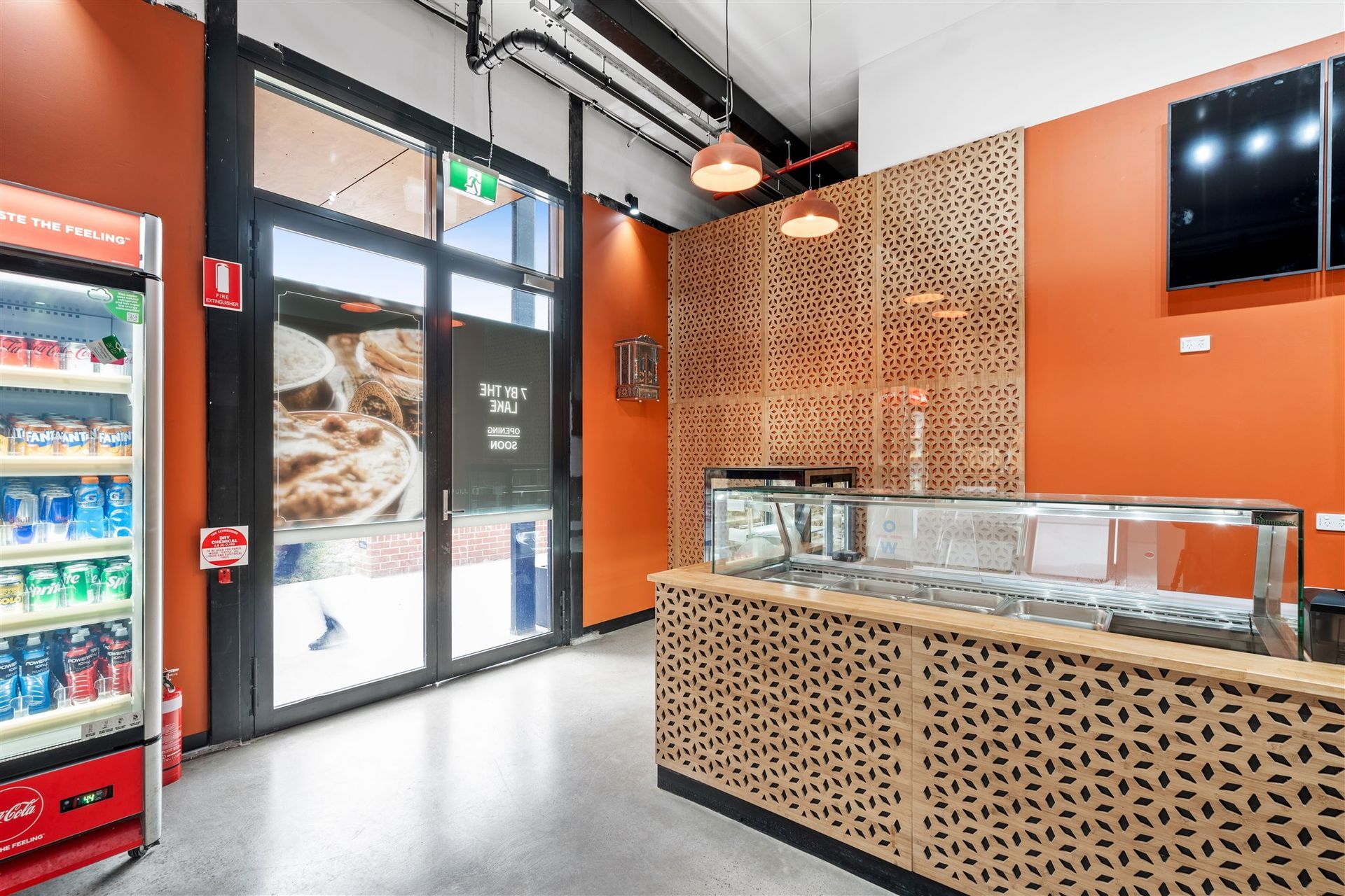The Inside of a Restaurant With a Counter and a Refrigerator — Moltus Construction in Braddon,  ACT