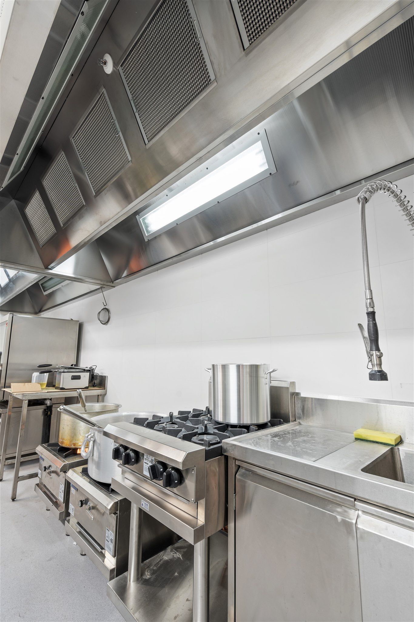 A Kitchen With Stainless Steel Appliances and a Sink — Moltus Construction in Braddon,  ACT