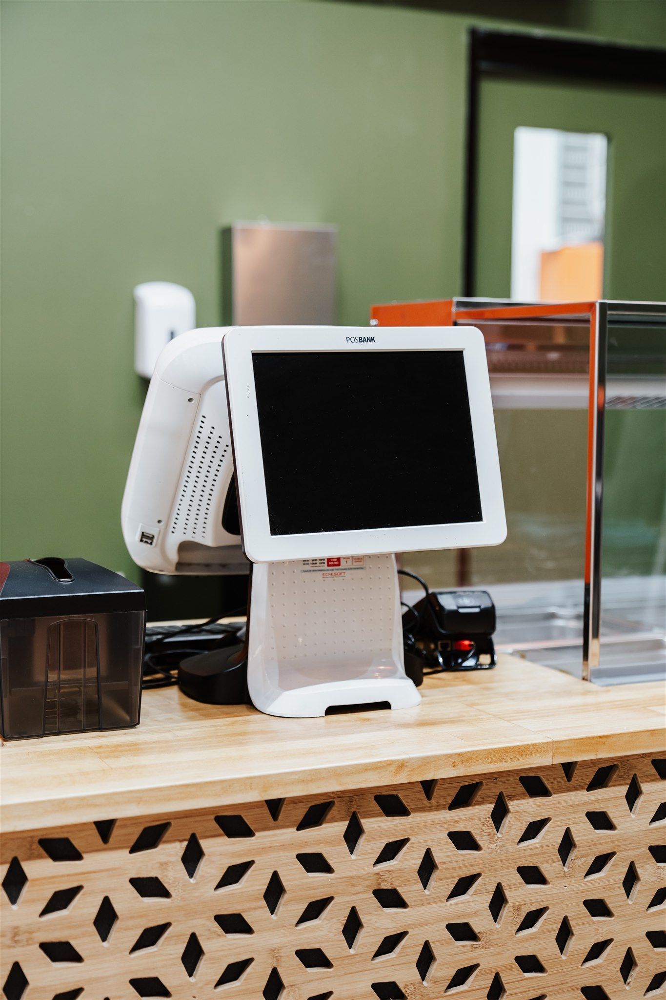 A Computer Monitor is Sitting on Top of a Wooden Counter — Moltus Construction in Braddon,  ACT