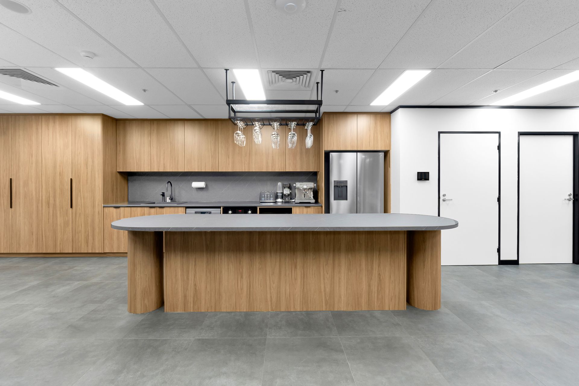 A Kitchen With Wooden Cabinets and a Large Island — Moltus Construction in Braddon,  ACT