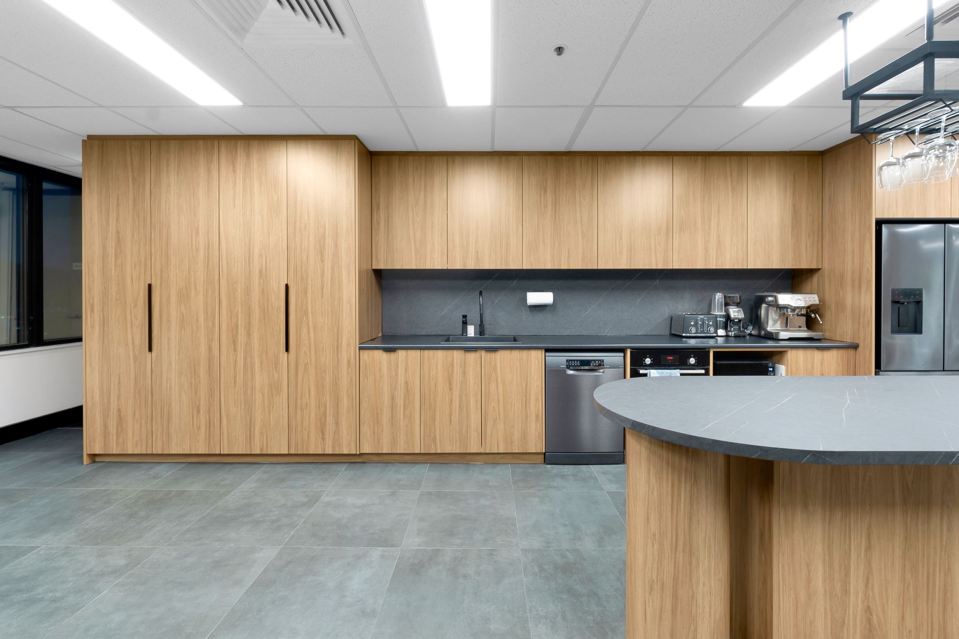 A Kitchen With Wooden Cabinets and a Gray Counter Top — Moltus Construction in Braddon, ACT