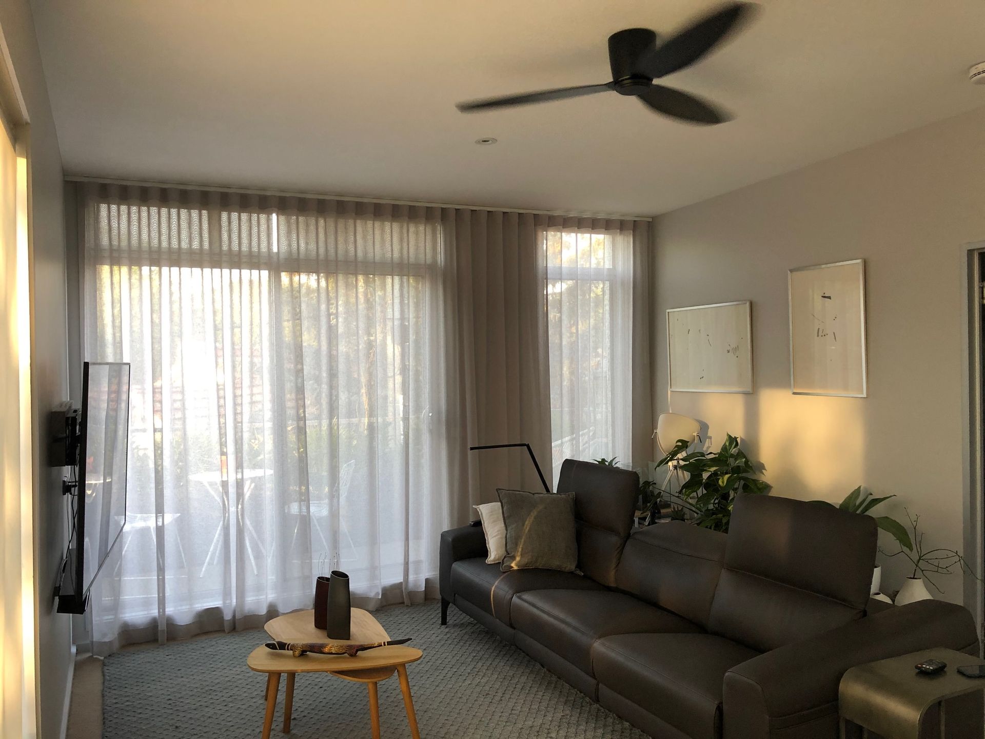 A Living Room with a Black Sofa— Moltus Construction in Braddon, ACT