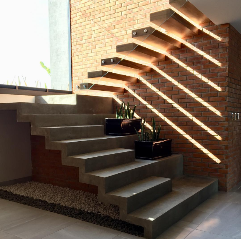 A Stairwell Near a Window with Plants on It— Moltus Construction in Braddon, ACT