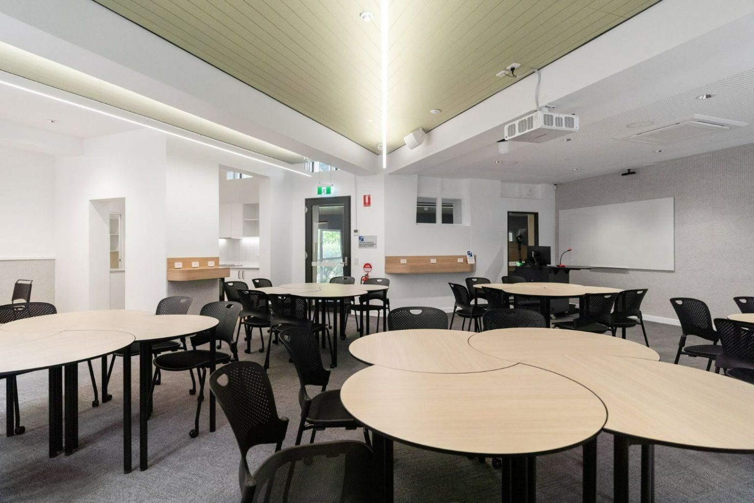A Large Room With Tables and Chairs in It — Moltus Construction in Braddon,  ACT