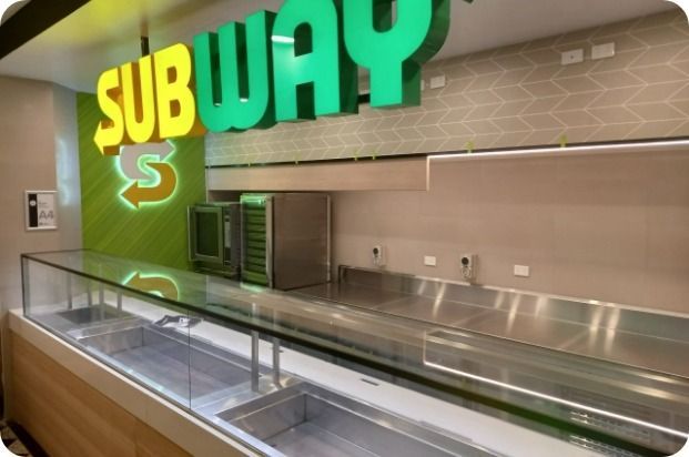 An Empty Subway Restaurant With a Glass Counter — Moltus Construction in Braddon,  ACT