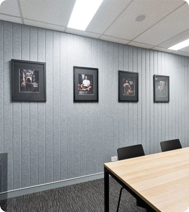 A Conference Room With A Table And Chairs And Pictures On The Wall — Moltus Construction in Braddon, ACT