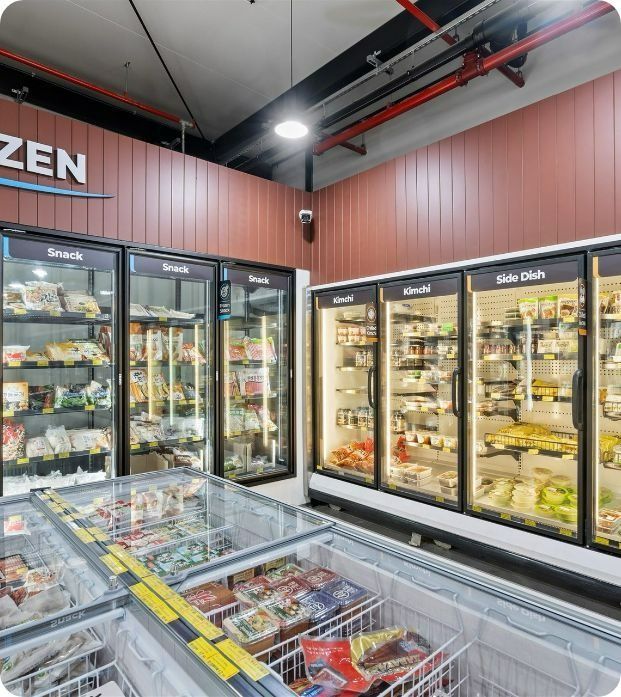 A Frozen Section of a Grocery Store Filled With Lots of Frozen Food — Moltus Construction in Braddon,  ACT