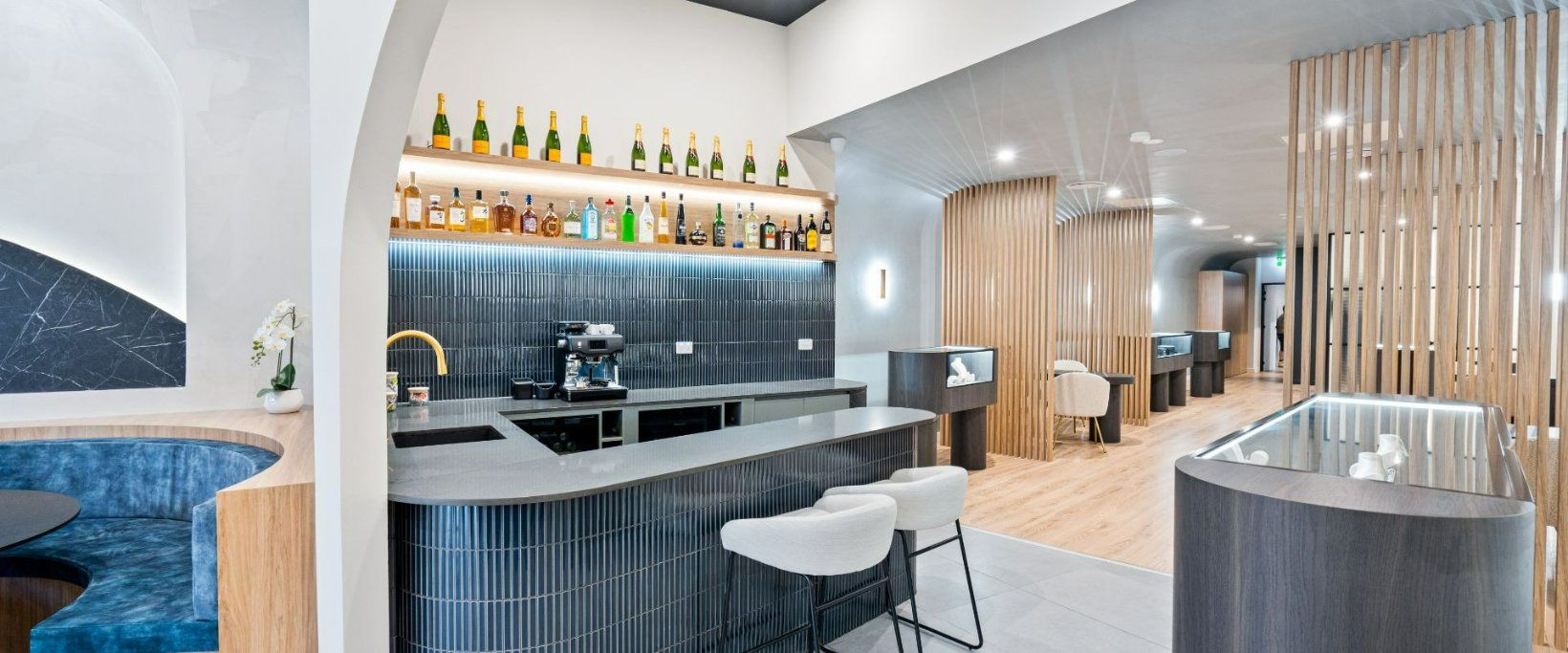 A bar With two stools at the Counter — Moltus Construction in Braddon, ACT