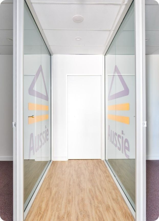 A Hallway With a Sign on the Wall That Says Aussie — Moltus Construction in Braddon,  ACT