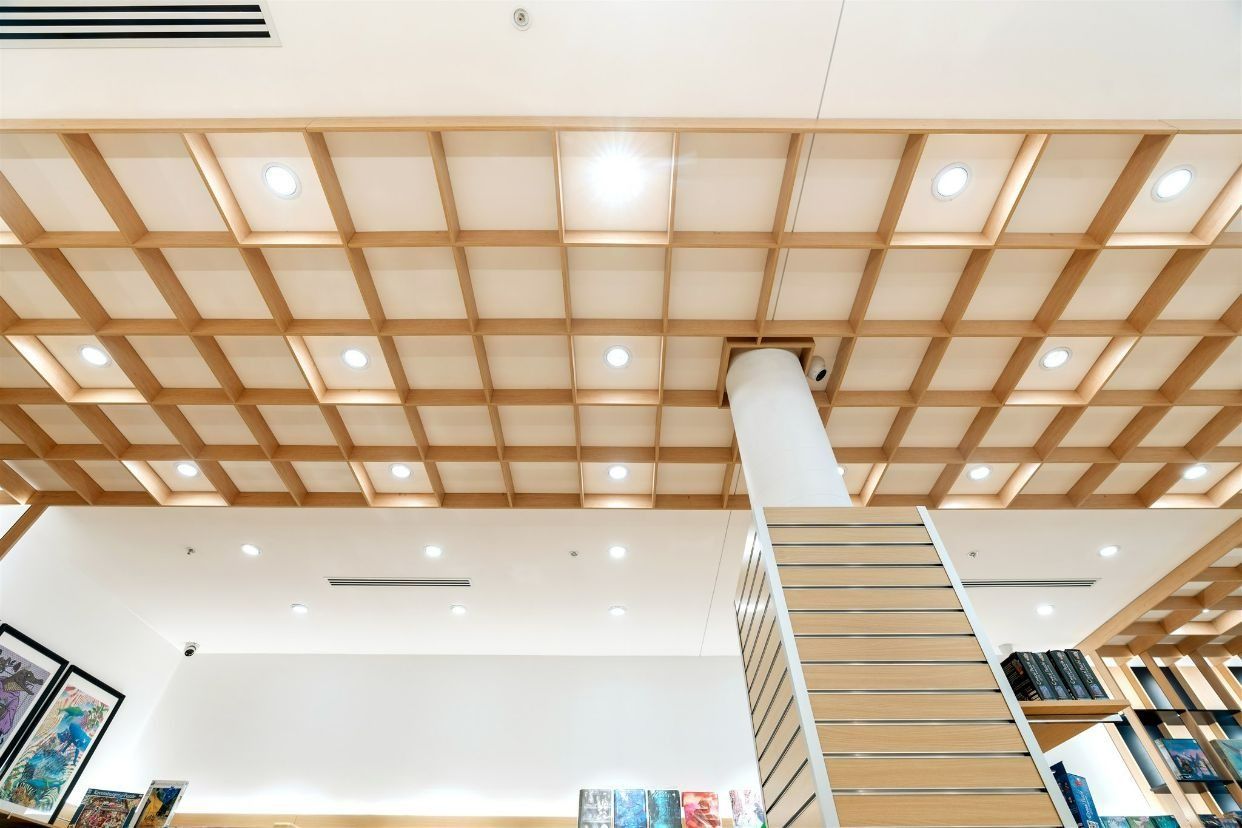 A Wooden Ceiling in a Library With Stairs Leading Up to It — Moltus Construction in Braddon,  ACT