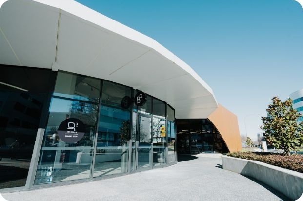 A Large Building With a Lot of Windows and a Sign That Says Cal — Moltus Construction in Braddon,  ACT